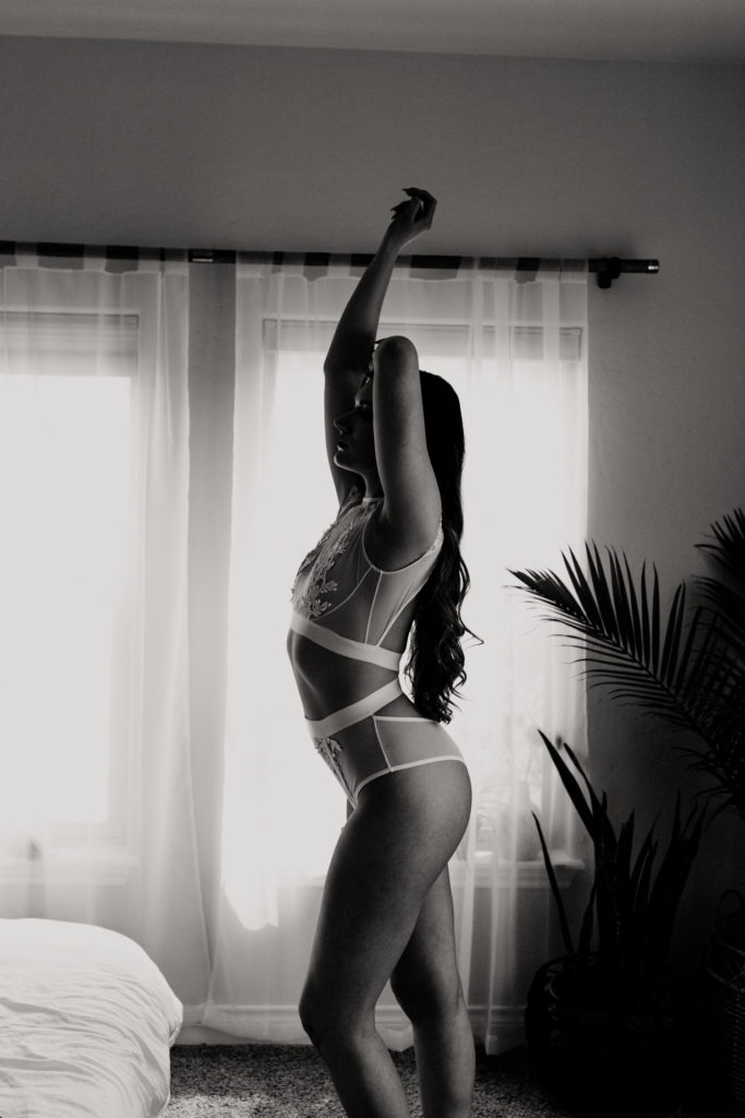 Black and white photo of a woman in yandy lingerie set for boudoir style portraiture